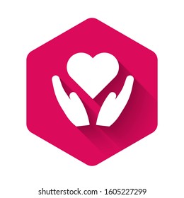 White Heart on hand icon isolated with long shadow. Hand giving love symbol. Valentines day symbol. Pink hexagon button. Vector Illustration