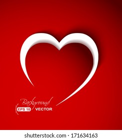 White heart shape cut from paper over red background.