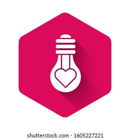 White Heart shape in a light bulb icon isolated with long shadow. Love symbol. Valentine day symbol. Pink hexagon button. Vector Illustration