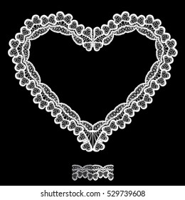 White Heart shape is made of lace doily isolated on black background. Frame element for Holiday Card, Valentines Day, Wedding invitation.