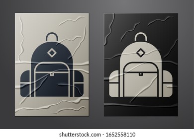 White Hiking backpack icon isolated on crumpled paper background. Camping and mountain exploring backpack. Paper art style. Vector Illustration