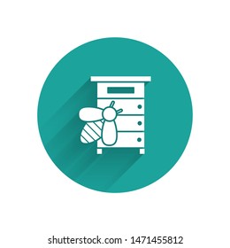 White Hive for bees icon isolated with long shadow. Beehive symbol. Apiary and beekeeping. Sweet natural food. Green circle button. Vector Illustration