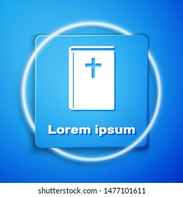 White Holy bible book icon isolated on blue background. Blue square button. Vector Illustration