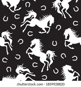 White horse and horseshoe silhouette on black background. Seamless pattern. Vector illustration.