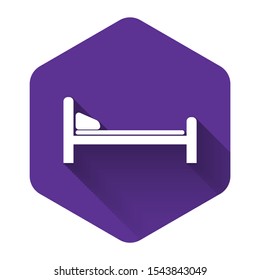 White Hospital Bed icon isolated with long shadow. Purple hexagon button. Vector Illustration