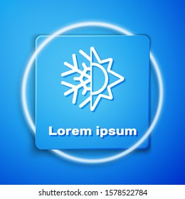 White Hot and cold symbol. Sun and snowflake icon isolated on blue background. Winter and summer symbol. Blue square button. Vector Illustration
