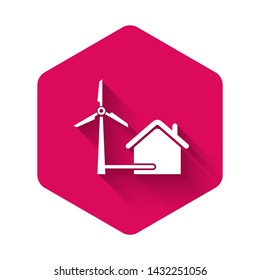 White House with wind turbine for electric energy generation icon isolated with long shadow. Eco-friendly house. Environmental Protection. Pink hexagon button. Vector Illustration