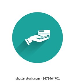 White Human hand holding with credit card icon isolated with long shadow. Online payment. Pay by card. Financial operations. Green circle button. Vector Illustration