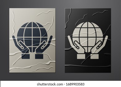 White Human hands holding Earth globe icon isolated on crumpled paper background. Save earth concept. Paper art style. Vector Illustration
