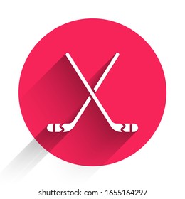 White Ice hockey sticks icon isolated with long shadow. Red circle button. Vector Illustration