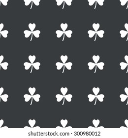 White image of clover leaf repeated on black background