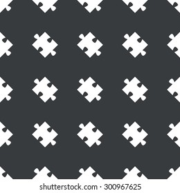 White image of puzzle piece repeated on black background