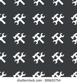 White image of wrench and hammer repeated on black background