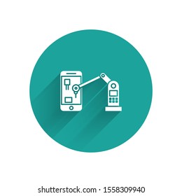 White Industrial machine robotic robot arm hand on mobile phone factory icon isolated with long shadow. Industrial robot manipulator. Green circle button. Vector Illustration