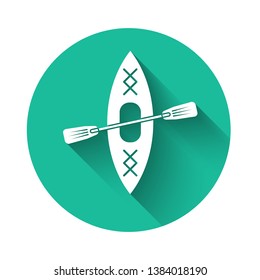 White Kayak and paddle icon isolated with long shadow. Kayak and canoe for fishing and tourism. Outdoor activities. Green circle button. Vector Illustration