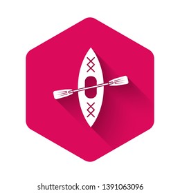 White Kayak and paddle icon isolated with long shadow. Kayak and canoe for fishing and tourism. Outdoor activities. Pink hexagon button. Vector Illustration