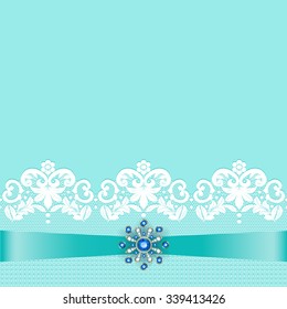 White lace border with ribbon and sapphire jewelery brooch on turquoise background for wedding card design