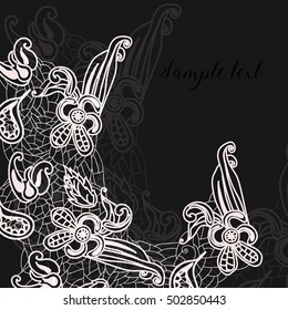 White lace on a black background. Flowers and leaves elements