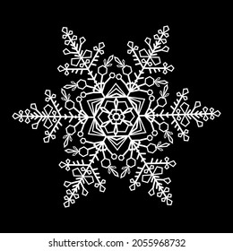 White lace snowflake on black background