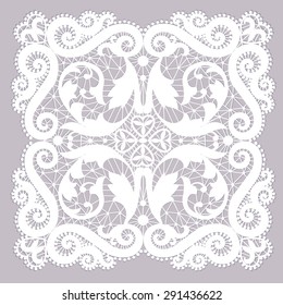 White lacy doily with flowery pattern on a gray background