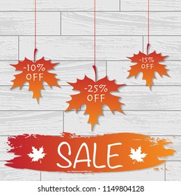 White laminate wooden texture background with autumn color leaves and sale discount text