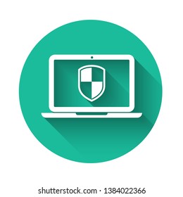 White Laptop protected with shield symbol icon isolated with long shadow. Internet security concept. PC security, firewall technology, privacy safety. Green circle button. Vector Illustration
