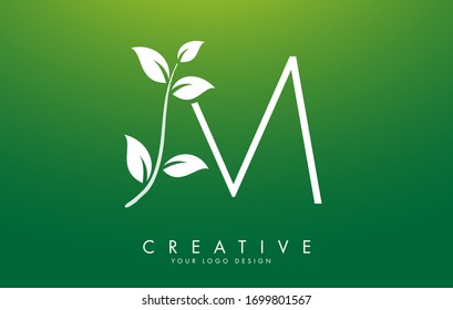 White Leaf Letter M Logo Design with Leaves on a Branch and Green Background. Letter M with nature concept. Eco and Organic Letter Vector Illustration. 