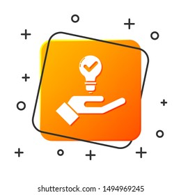 White Light bulb in hand icon isolated on white background. Concept of idea. Orange square button. Vector Illustration