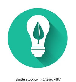 White Light bulb with leaf icon isolated with long shadow. Eco energy concept. Alternative energy concept. Green circle button. Vector Illustration