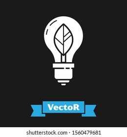 White Light bulb with leaf icon isolated on black background. Eco energy concept. Alternative energy concept.  Vector Illustration