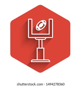 White line American football goal post and football ball icon isolated with long shadow. Red hexagon button. Vector Illustration
