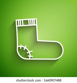 White line Baby socks clothes icon isolated on green background.  Vector Illustration