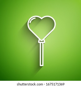 White line Balloons in form of heart with ribbon icon isolated on green background.  Vector Illustration
