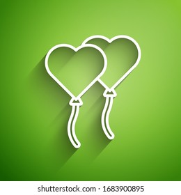 White line Balloons in form of heart with ribbon icon isolated on green background. Valentines day.  Vector Illustration