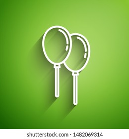 White line Balloons with ribbon icon isolated on green background.  Vector Illustration