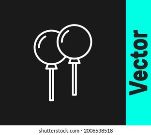 White line Balloons with ribbon icon isolated on black background.  Vector
