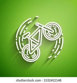 White line Bicycle trick icon isolated on green background. Bike race. Extreme sport. Sport equipment.  Vector Illustration