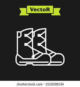 White line Boots icon isolated on black background.  Vector Illustration