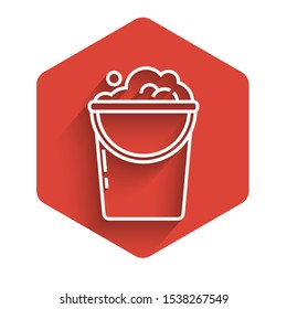 White line Bucket with foam and bubbles icon isolated with long shadow. Cleaning service concept. Red hexagon button. Vector Illustration