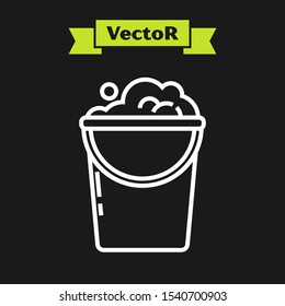 White line Bucket with foam and bubbles icon isolated on black background. Cleaning service concept.  Vector Illustration