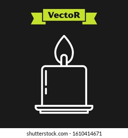 White line Burning candle in candlestick icon isolated on black background. Cylindrical candle stick with burning flame.  Vector Illustration