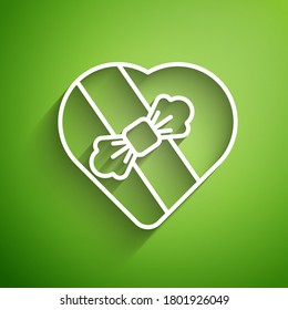 White line Candy in heart shaped box and bow icon isolated on green background. Valentines Day.  Vector Illustration