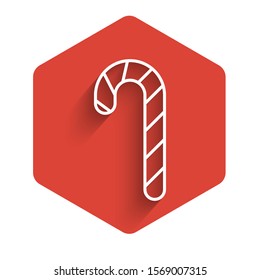 White line Christmas candy cane with stripes icon isolated with long shadow. Merry Christmas and Happy New Year. Red hexagon button. Vector Illustration