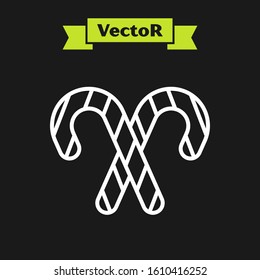 White line Christmas candy cane with stripes icon isolated on black background. Merry Christmas and Happy New Year.  Vector Illustration