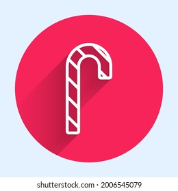 White line Christmas candy cane with stripes icon isolated with long shadow. Merry Christmas and Happy New Year. Red circle button. Vector