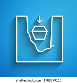 White line Coffin in grave icon isolated on blue background. Funeral ceremony. Long shadow. Vector
