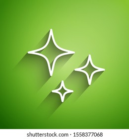 White line Falling star icon isolated on green background. Shooting star with star trail. Meteoroid, meteorite, comet, asteroid, star icon.  Vector Illustration