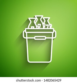 White line Fishing bucket with fishes icon isolated on green background. Fish in a bucket.  Vector Illustration