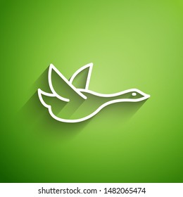 White line Flying duck icon isolated on green background.  Vector Illustration
