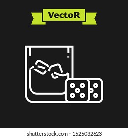 White line Game dice and glass of whiskey with ice cubes icon isolated on black background. Casino gambling.  Vector Illustration